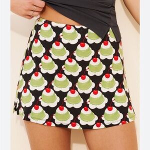 Lisa Says Gah Black Mini skort with Green Dessert & Red Cherry Print